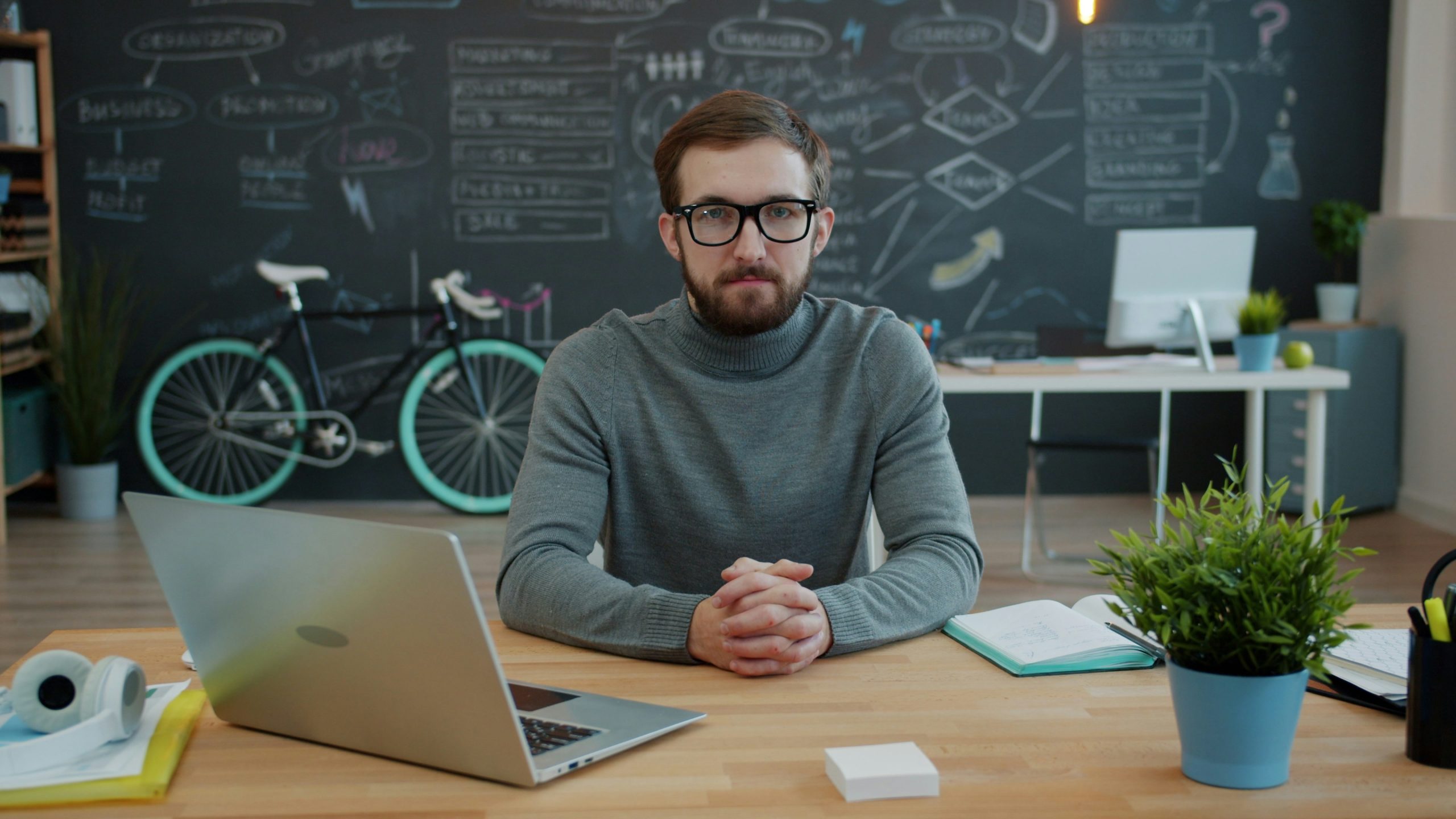 professionally dressed man sitting at a desk